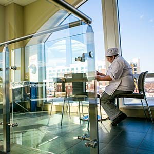 Culinary arts student reading at a table