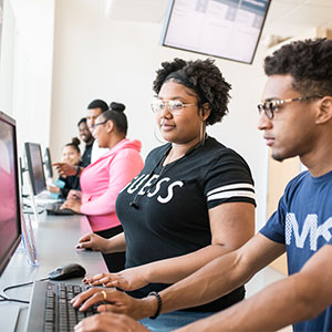 Female and male college student at computer station