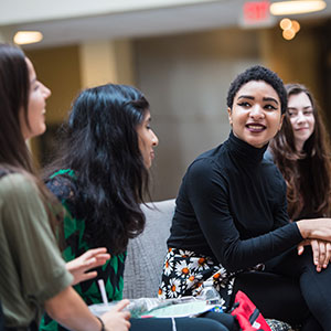 Girls talking, one in black shirt