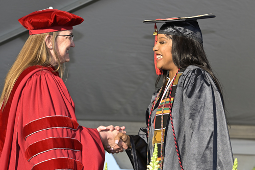 Dr. Victoria Bastecki-Perez shaking hands with graduate