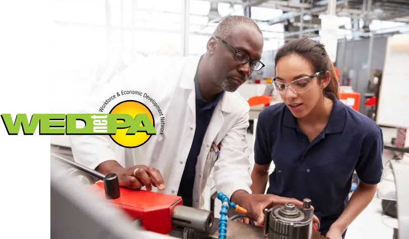 Two technicians inspecting a mechanical part