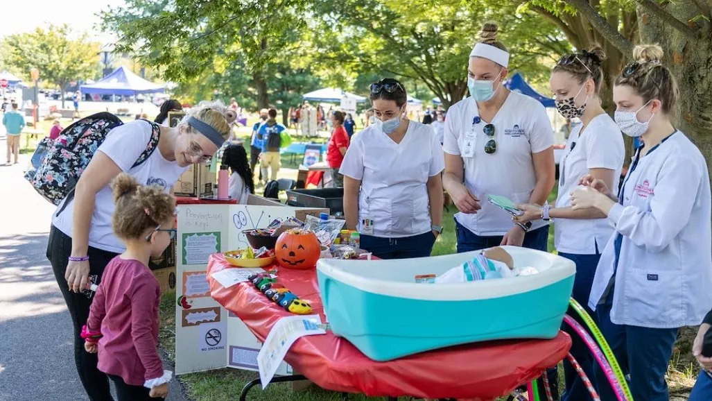 a group of people standing around a table