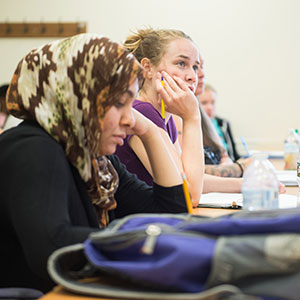 Female student focusing on instructor (not pictured)