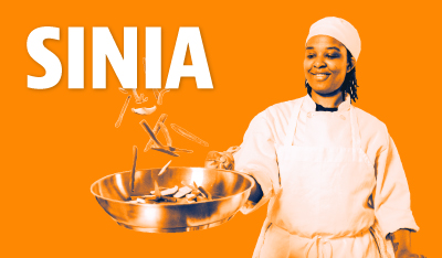 Image of Sinia tossing food in a pan with orange filter applied