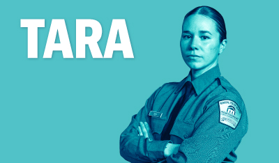 Image of Tara with her arms crossed in her Police Academy uniform