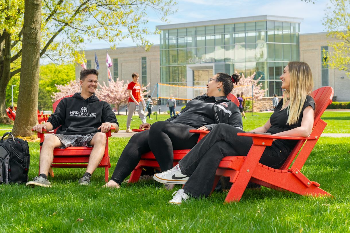 Students sitting outside in the Blue Bell campus quad area