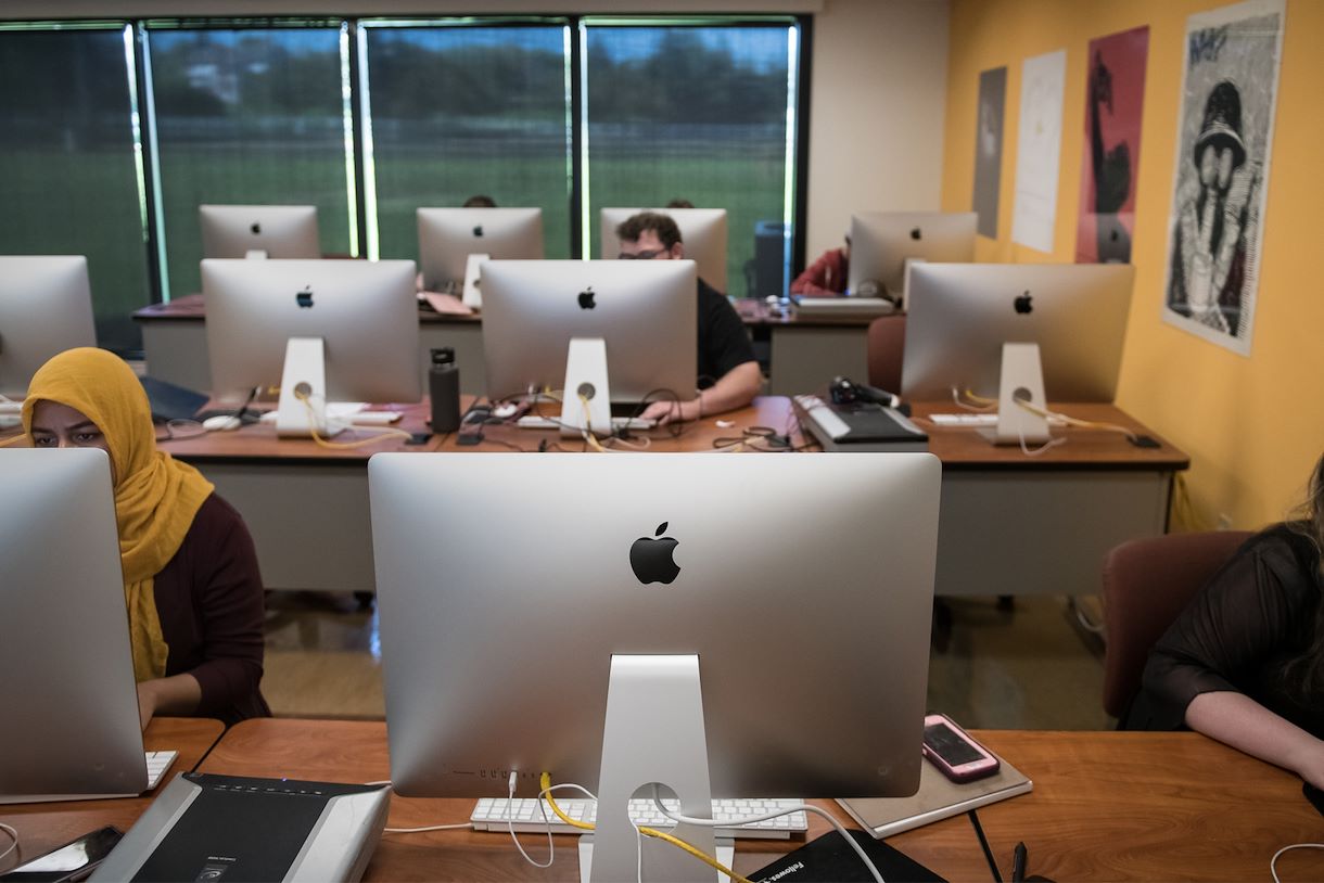 Image of a digital arts class filled with computers