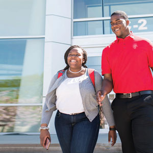 Female and male student walking together