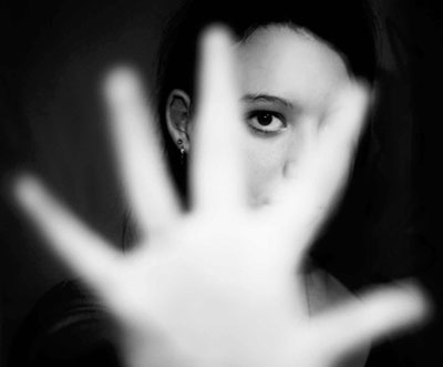 Hand with person in background in black and white