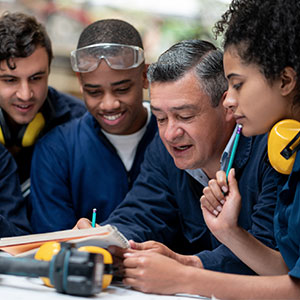 Teacher talking to a group of industrial design students stock photo