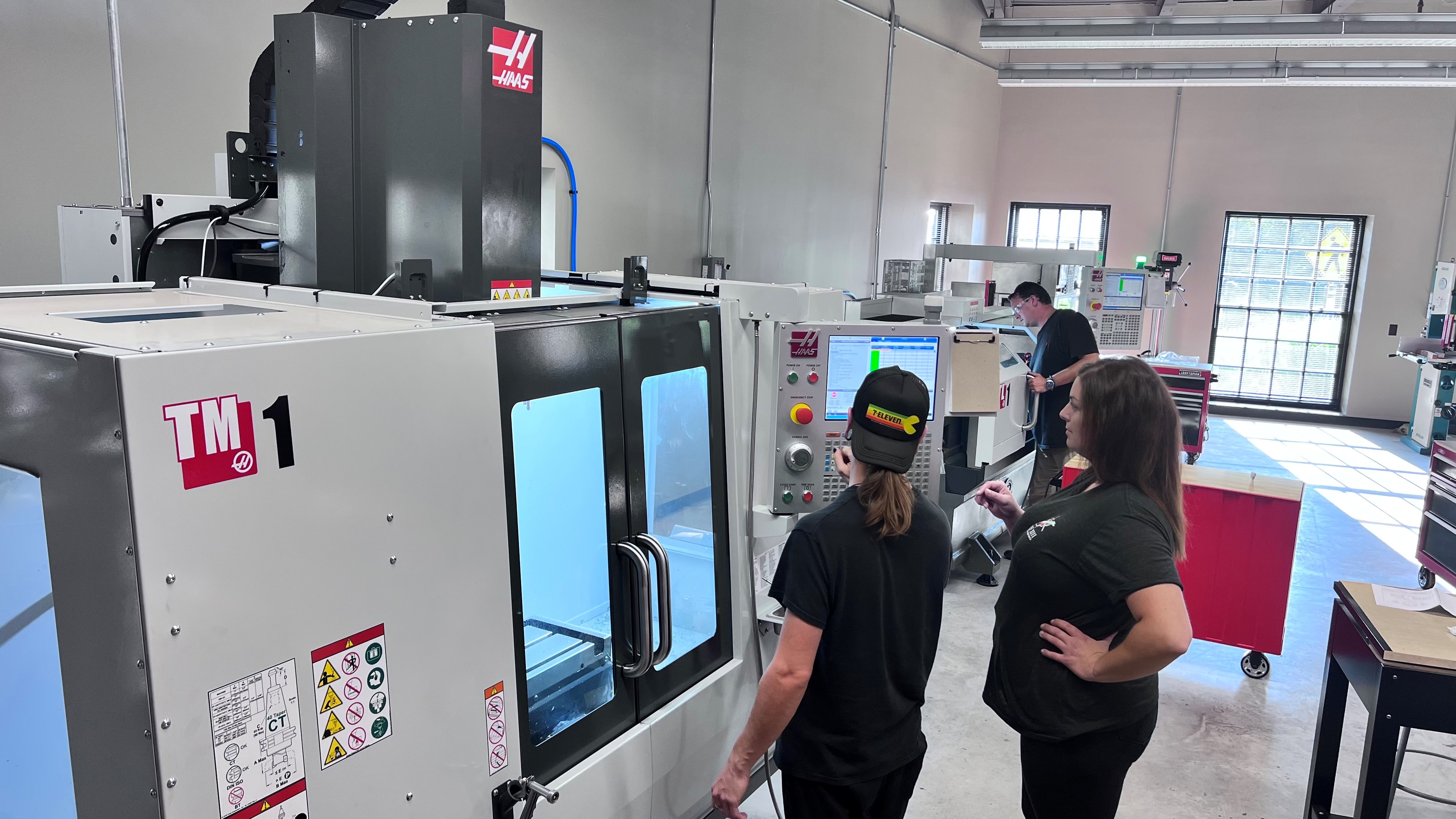 Students operating a CNC machine