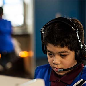 Male student wearing a headset participates in the Virtual Missions