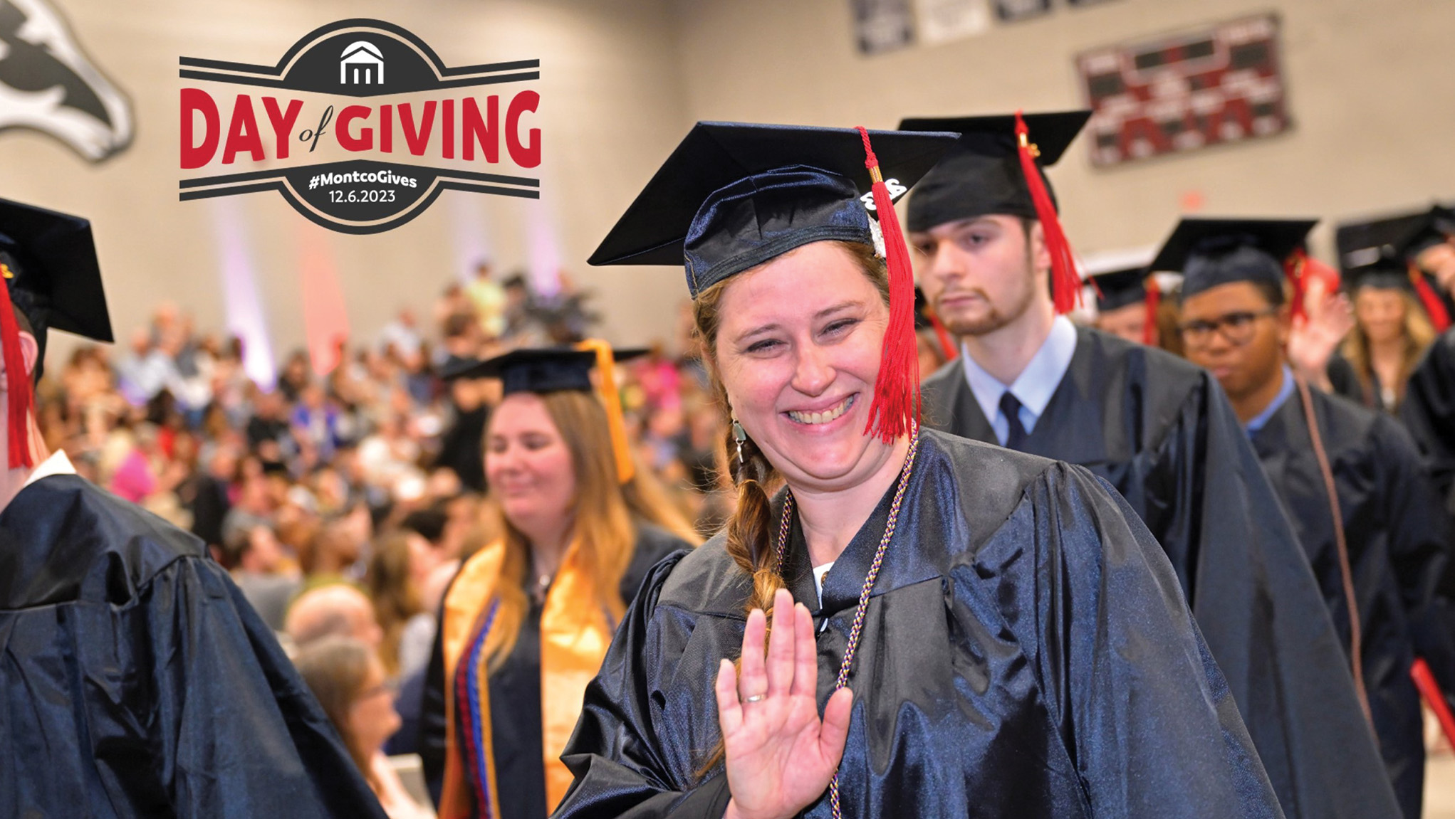 Graduate waving with Day of Giving logo