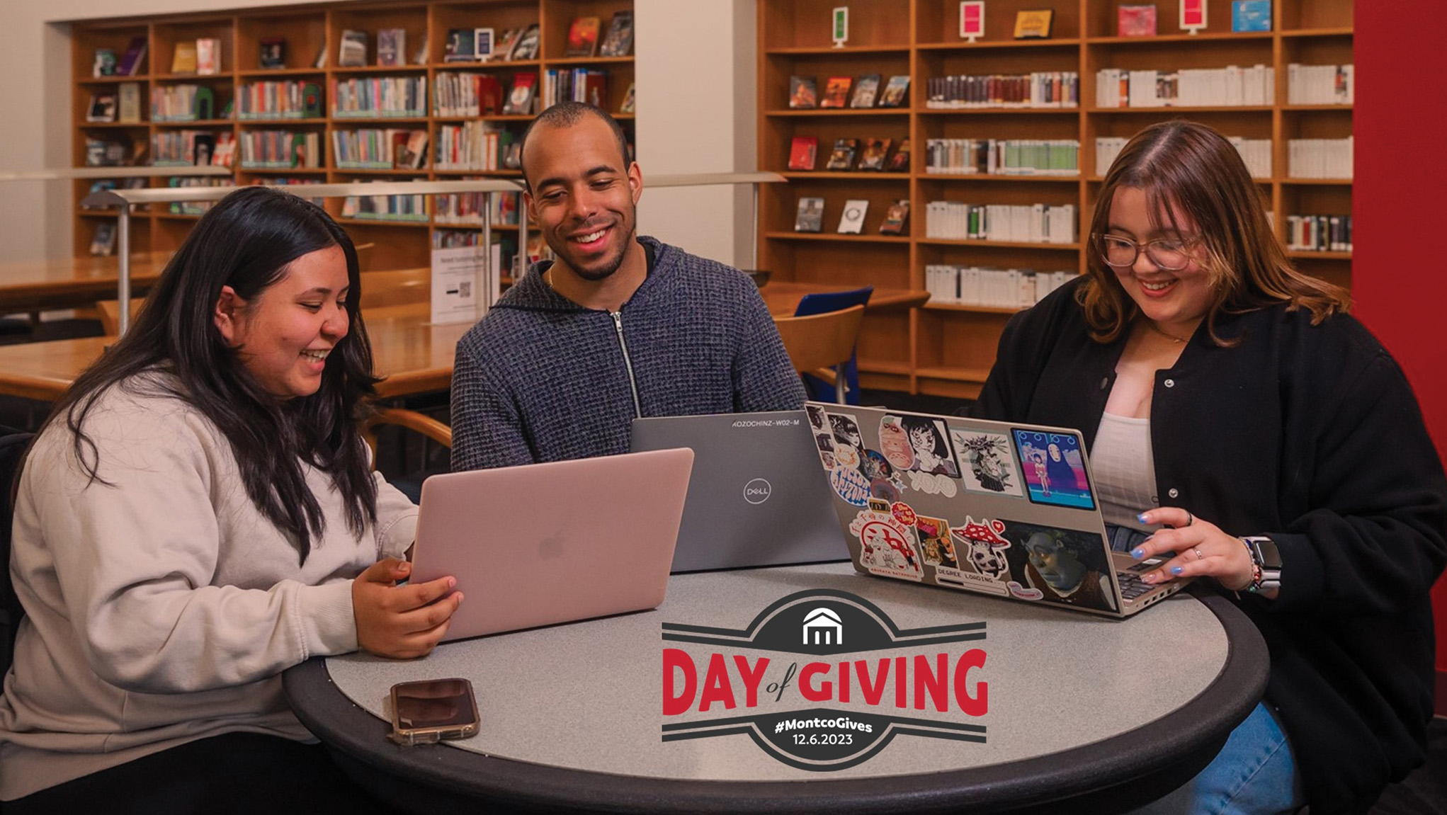 Students working on laptops in library and Day of Giving logo