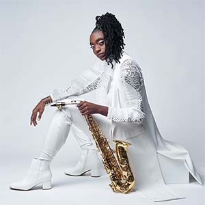 Close up of Lakecia Benjamin holding a saxophone