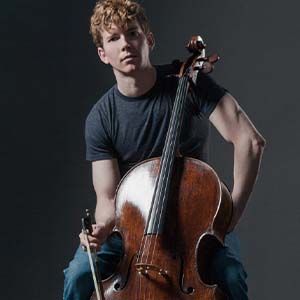 Joshua Roman posing with his cello