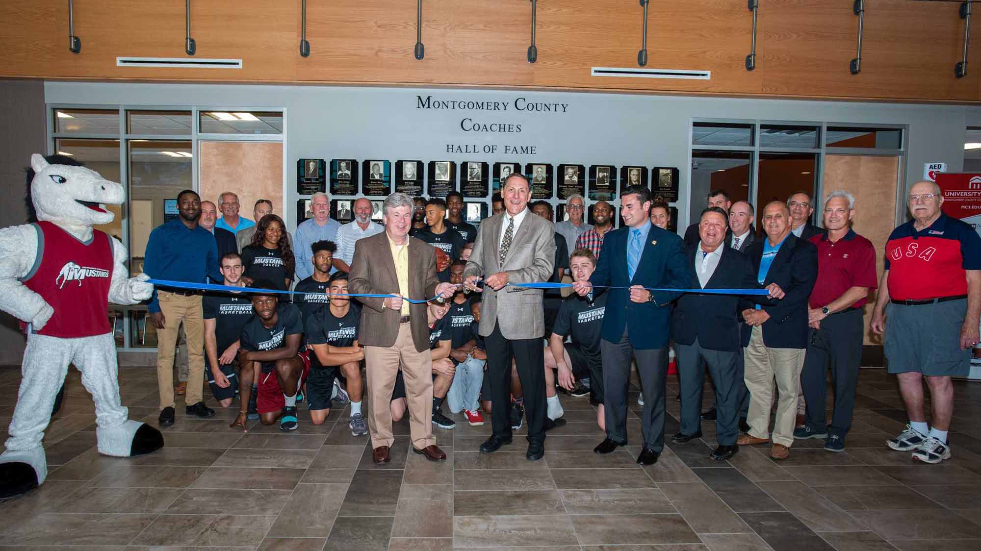 Members of the Coaches Hall of Fame Advisory Board together with Montgomery County Commissioner Joseph Gale, MCCC President Dr. Kevin Pollock, the Mustangs men’s basketball team and visitors celebrated the unveiling of the Hall of Fame located in Montco's Health Sciences Building in Blue Bell.