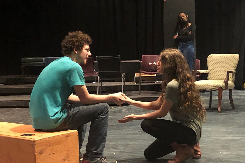 Andrew Campbell (sitting), Kiarah Guzman (kneeling) and Mersha Wamba (standing) perform a scene from “Hedda Gabler.” Photo by Matthew Moorhead