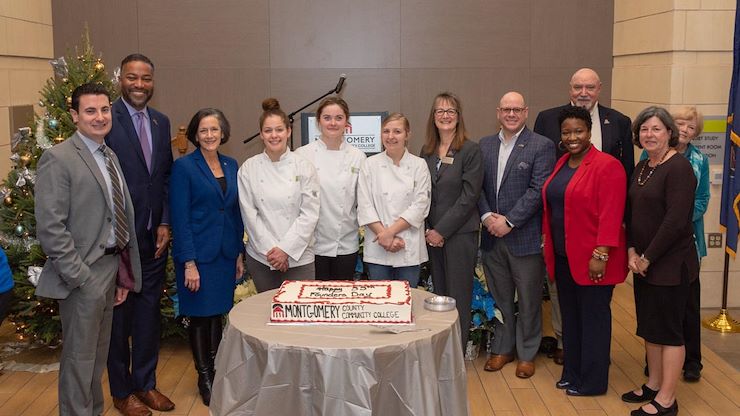 MCCC's Culinary Arts students prepared a special cake for the college's 55th anniversary. From left: Montgomery County Commissioner Joseph C. Gale, Montgomery County Commissioner Vice Chair Kenneth E. Lawrence, Jr., Montgomery County Commissioner Chair Dr. Valerie Arkoosh, Theresa Musso, Isabella Vitelli, Alexa Person, MCCC Interim President Dr. Victoria Basteck-Perez, MCCC Alumni Association Board Chair William Vitiello, MCCC Board of Trustees Chair Frank X. Custer, MCCC Public Health Instructor Gifty Key, Achieving the Dream President/CEO & MCCC President Emerita Dr. Karen A. Stout and MCCC Psychology Professor Dr. Mary Lou Whitehill. Photo by Linda Johnson