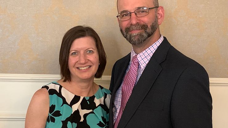 Education Senior Lecturer Lara Ferris, standing with her husband Paul, is a recipient of the Teaching Excellence Award. She was honored with the award during an online ceremony Oct. 7.
