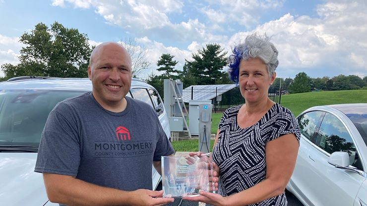 Jacqui Baxter-Rollins, Executive Director of The Partnership TMA of Montgomery County, presented Kyle Longacre, Dean of Workforce and Economic Development, with the platinum sponsorship recognition award for MCCC’s support of its “Electric Vehicles Lunch and Learn Event,” held Friday, June 11, at Parkside Place Pavilion in North Wales.