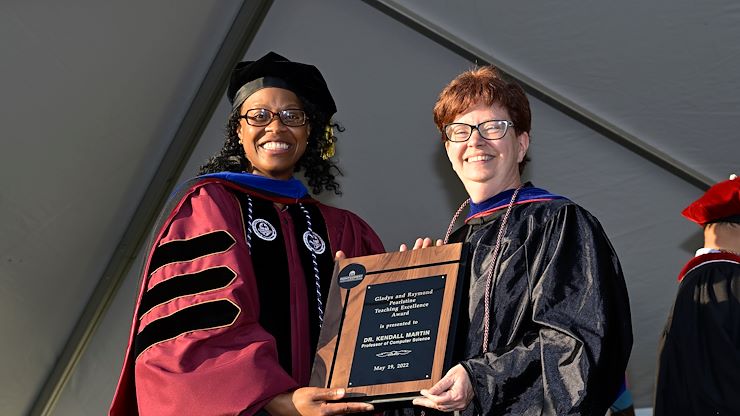 Dr. Kendall Martin, Computer Science professor (right), stands with Dr. Gloria Oikelome, Vice President of Academic Affairs, at Commencement to accept the 2022 Gladys and Raymond Pearlstine Award for Teaching Excellence. Photos by Dave DeBalko.