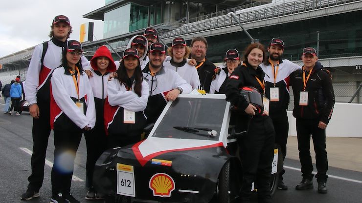 Engineering Science students on the Project Innova team stand with their car during the Shell Eco-marathon Challenge international competition at the Indianapolis Motor Speedway. Photo courtesy of Griff Francis.