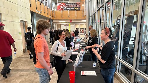 A volunteer answers questions during an open house event in the Health Sciences Center on Blue Bell Campus.