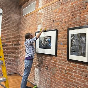 Galleries Director Patrick Rodgers hangs Blind Visionaries photography
