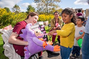 Dental hygiene students show children how to brush their teeth 