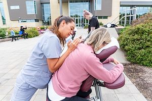 Massage therapy students massage visitors