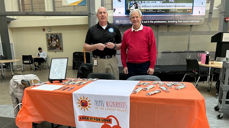 Fred Goldstein, Communications Studies Senior Lecturer, and Lee Allan, Senior Director of Campus Safety, distribute gunlocks on April 17 to promote child safety and suicide prevention. Photo by Eric Devlin