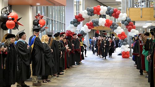class of 2025 procession into gym in the Health Sciences Center in Blue Bell