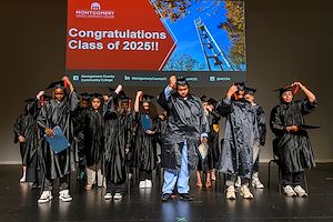 Gateway to College graduates move the tassel on their caps