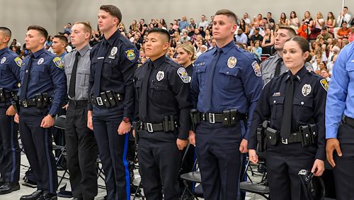 Municipal Police Academy cadets stand at attention during the program's graduation ceremony.