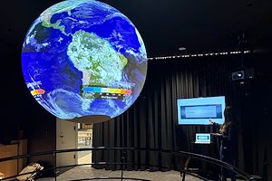 Delilah Freitas, a Montgomery County Community College Communications Studies110 student, presents a speech on climate change using the Science on a Sphere® in the lobby of South Hall on the Pottstown Campus