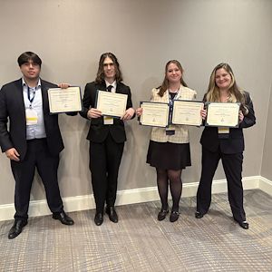 FBLA competition winners hold up their individual certificates