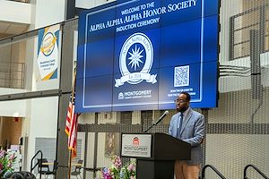 Shawn Murray, Hospitality Management Associate Professor and Advisor to Montgomery County Community College’s Beta Alpha Chapter of the Alpha Alpha Alpha National Honor Society for first generation college students speaks at the lectern