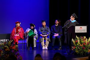 Michelle Kullas speaks to the Gateway to College graduates on stage at the lectern