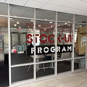 Montgomery County Community College Stock-Up Program room featuring an image of a brown paper bag with the College brand on the front.