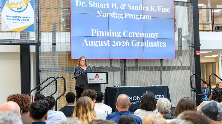 Nursing instructor Kelly Lyles speaks to graduates and attendees