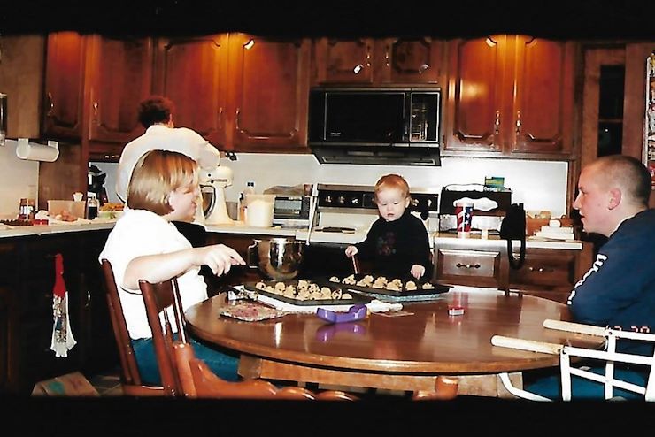 Abigail as a child helping to bake cookies