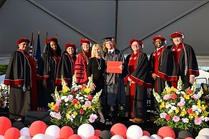 Leo Sereni and his mom, Ayisha, with the President and members of the Board of Trustees.