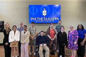 Aaron Laws stands with Phi Theta Kappa inductees on the Pottstown Campus