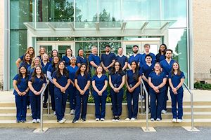 Class of 2026 Nursing program graduates in front of the Science Center in a group shot