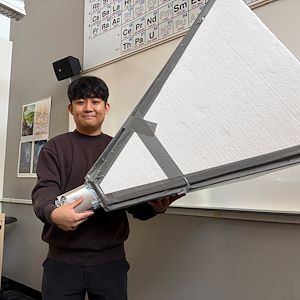 Joshua Jang holds up a horn radio telescope