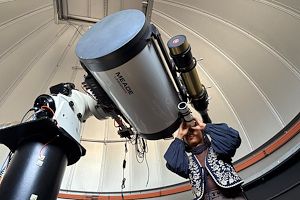 Loujain Ahmed looks into a telescope inside the Blue Bell observatory