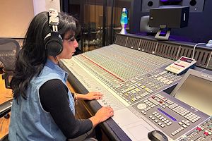 Mia Fanelli listens to a recording in the Mix Room on the Blue Bell Campus