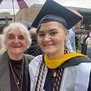 Taylor Bellegue dressed in a cap and gown at the West Chester University Commencement ceremony